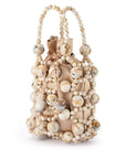 Beige handbag with shell embellishments on a white background