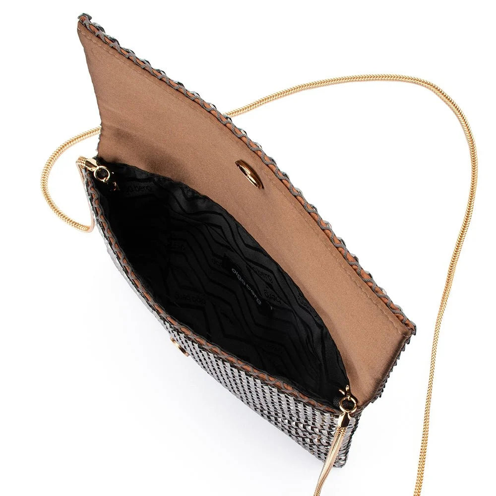 A top-down view of a woven clutch bag with a textured black and silver pattern, a tan interior lining, gold-tone hardware, and a thin gold chain strap on a white background.