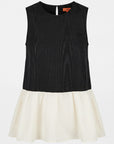 A sleeveless color-block dress with a black textured top and an off-white flared skirt, shown against a plain light gray background.