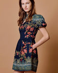 model wearing sveti mini dress on tan background