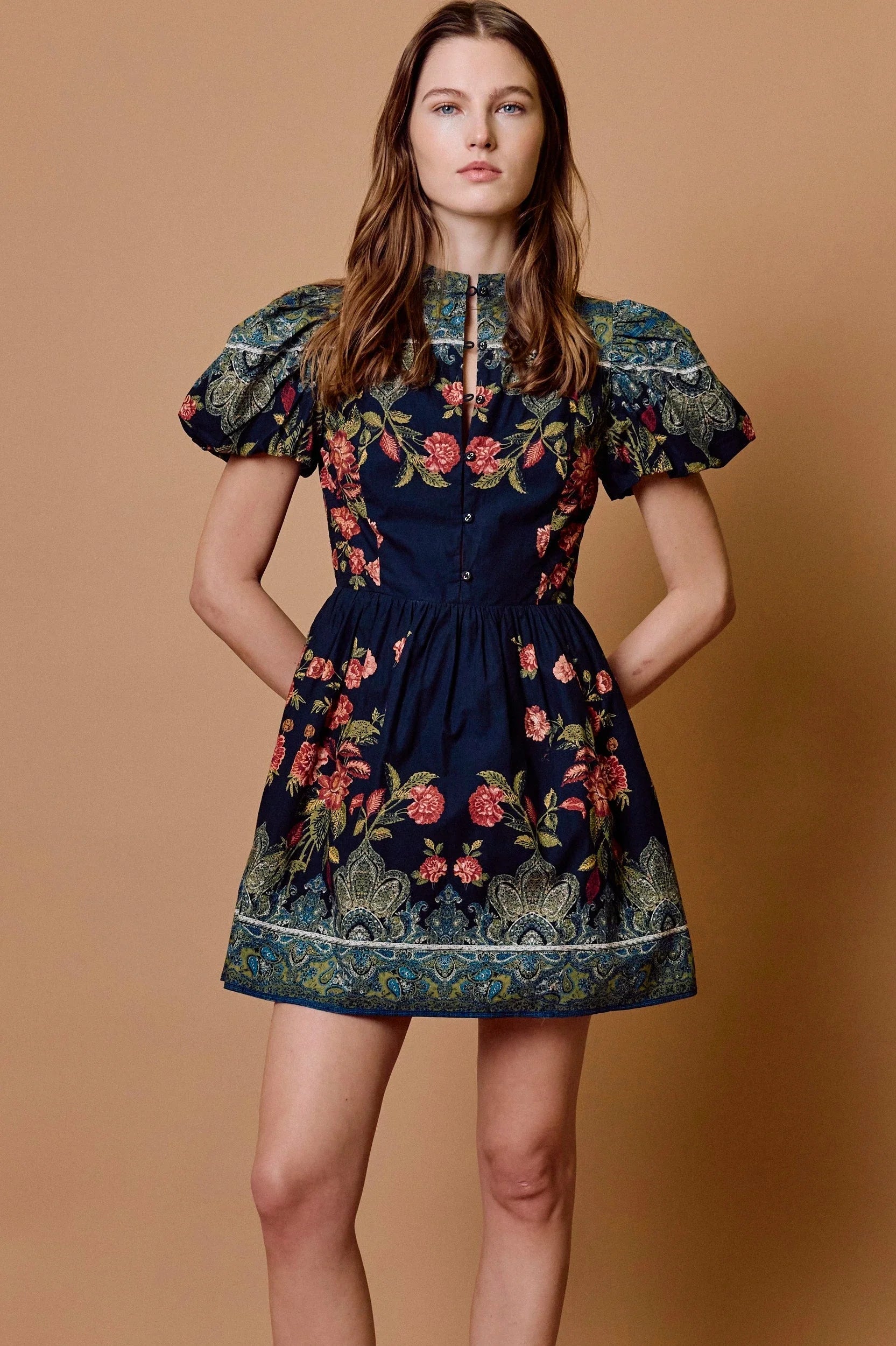 model wearing sveti mini dress on tan background