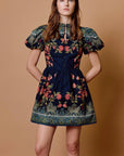 model wearing sveti mini dress on tan background