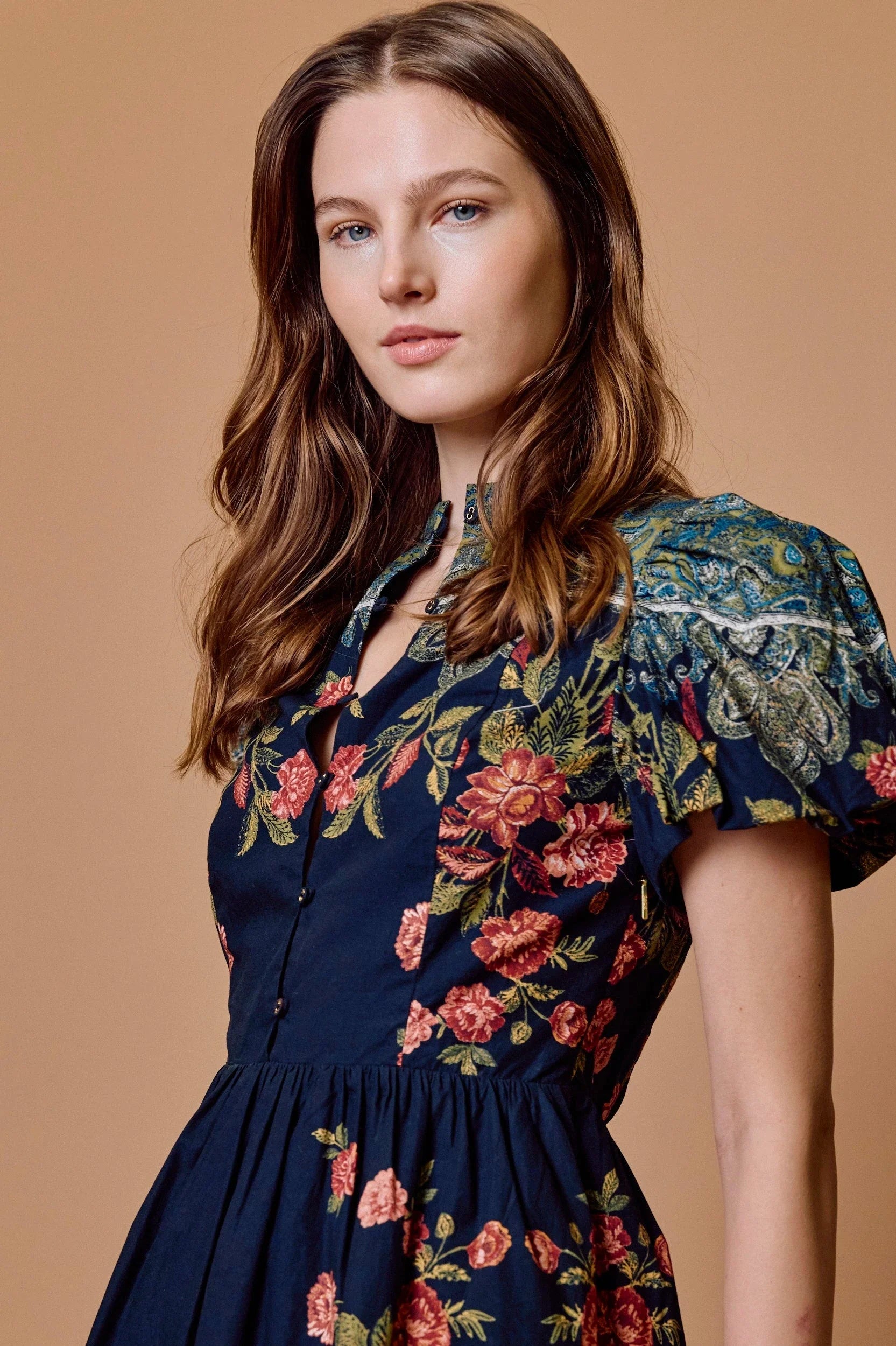 model wearing sveti mini dress on tan background