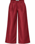wine colored pants with pleats and belt loops on a white background