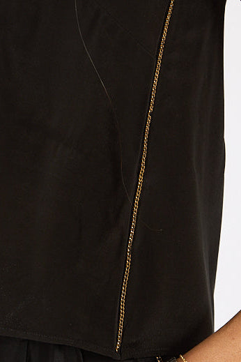 Black sleeveless top with a gold chain detail on a white background