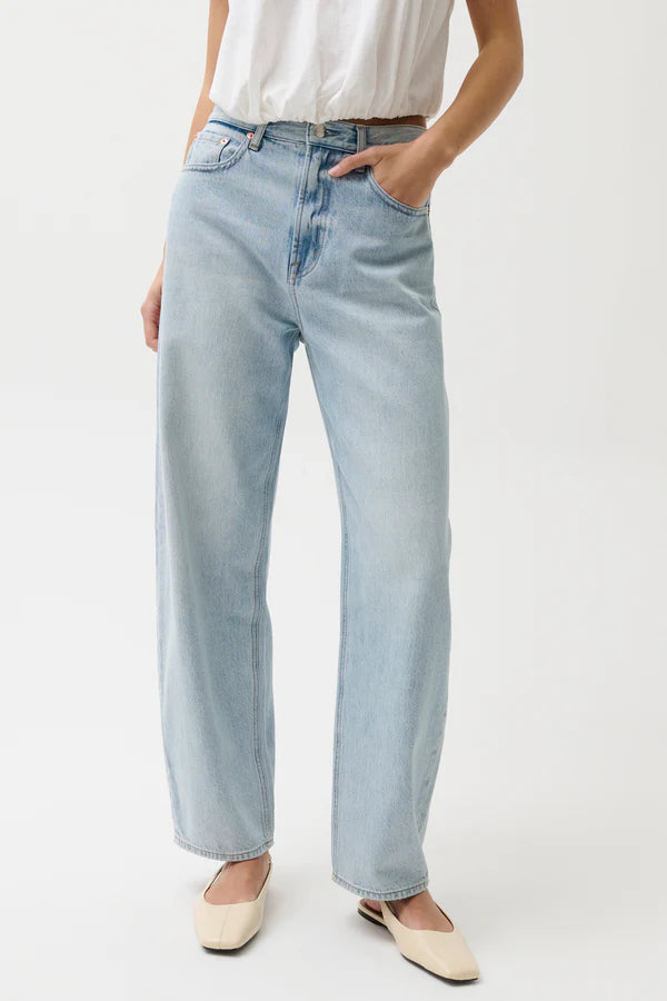 Light blue jeans worn by a person on a white background