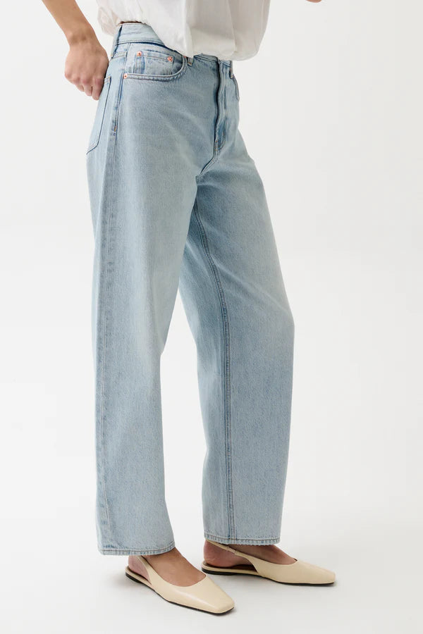 Light blue jeans worn by a person on a white background