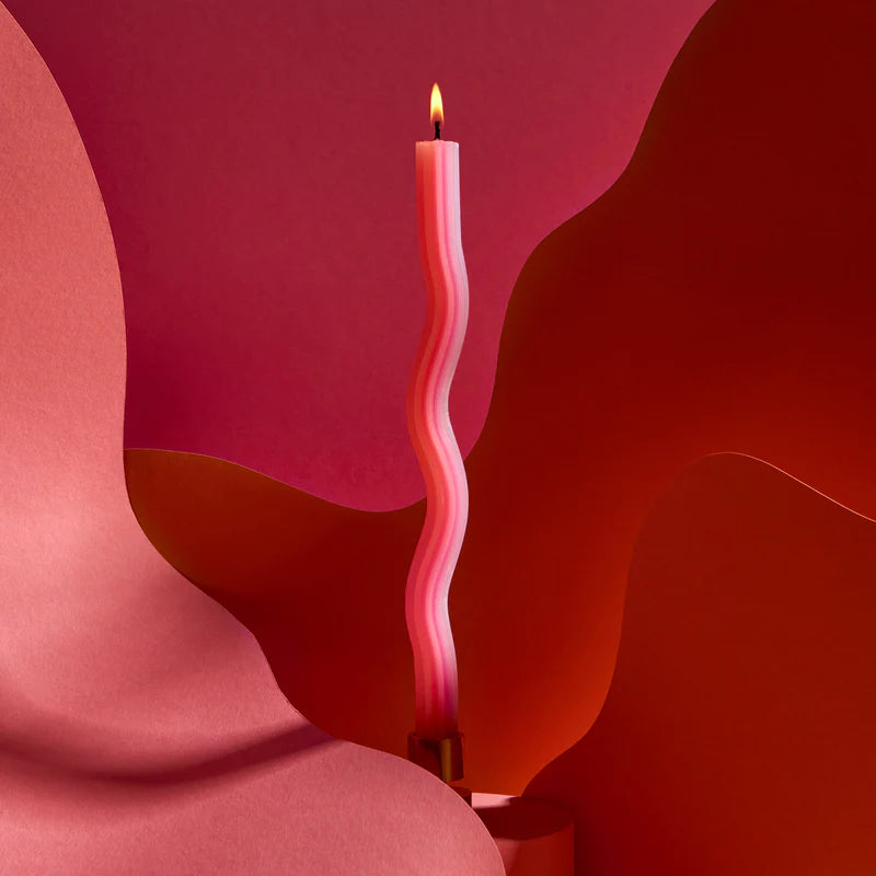 Wavy pink candle on a abstract red and pink background