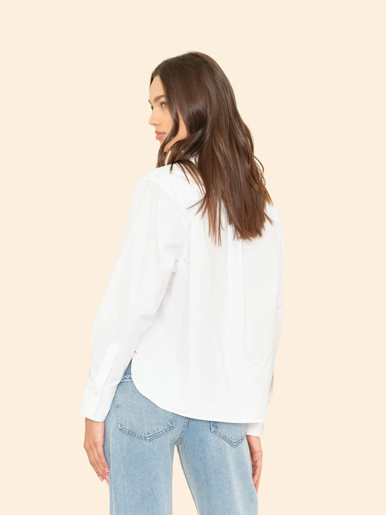 Woman wearing White Monroe Shirt and light blue jeans on a beige background