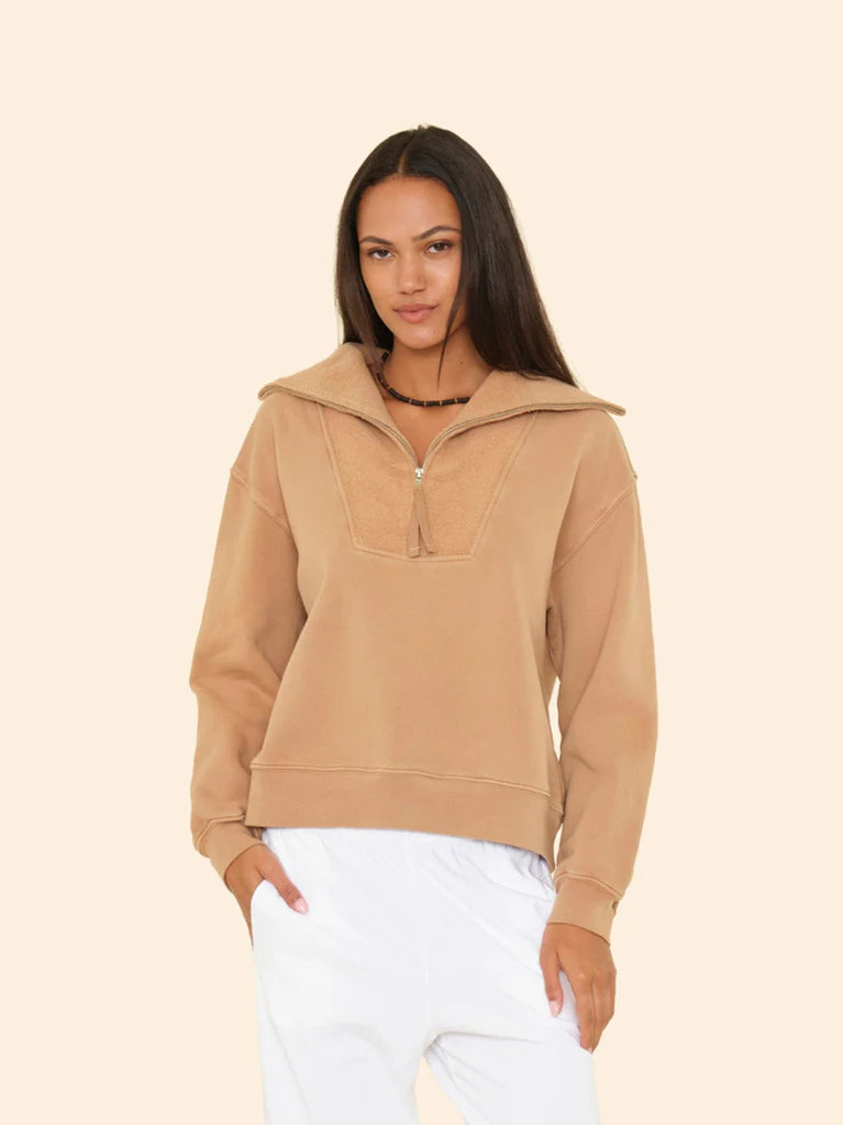 Woman wearing Kat Sweatshirt on a beige background