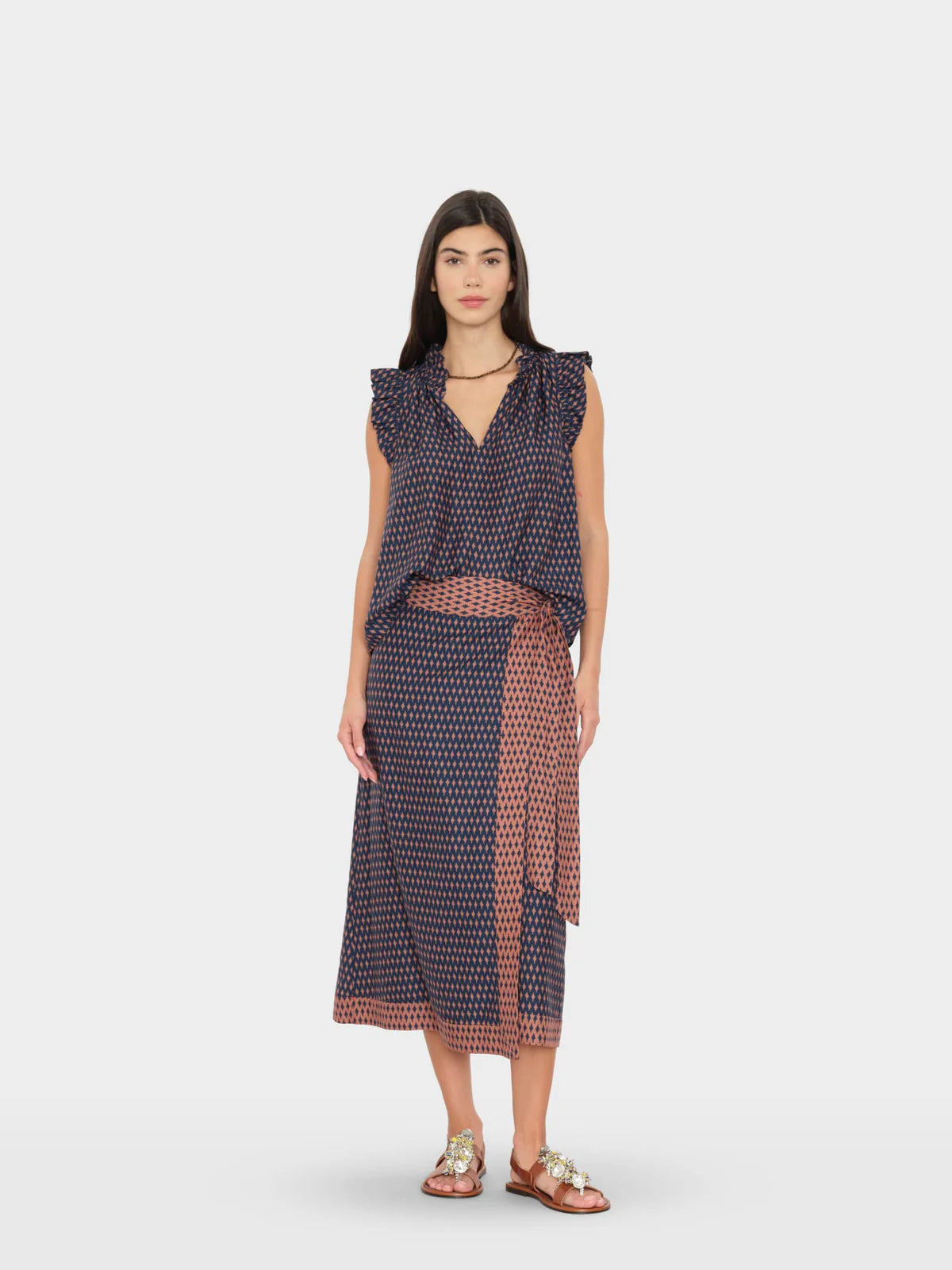 Woman wearing a patterned dress on a white background