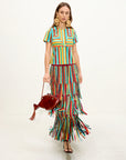 Woman wearing a colorful striped skirt with a white background
